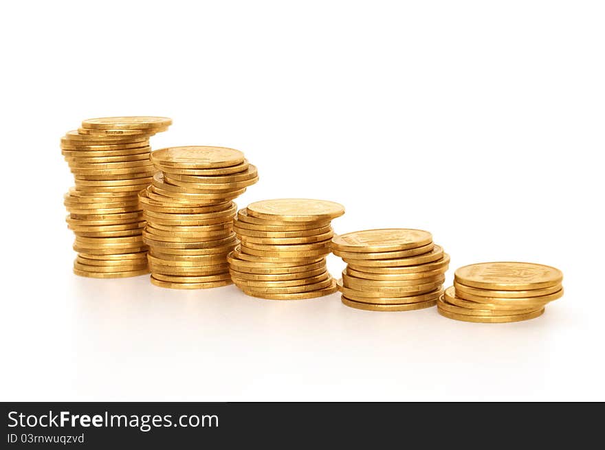 Side view of stacks of coins increasing in height, on white studio background. Side view of stacks of coins increasing in height, on white studio background