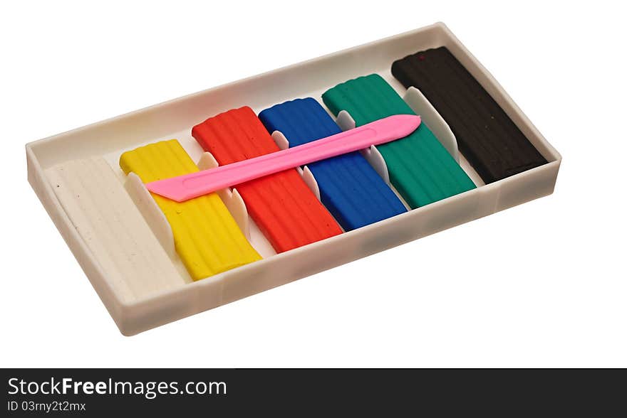 Color children's plasticine lies on a white background