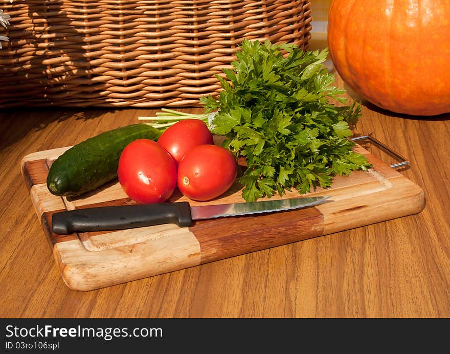 The suite from summer vegetables for salad luing on the wooden board. The suite from summer vegetables for salad luing on the wooden board