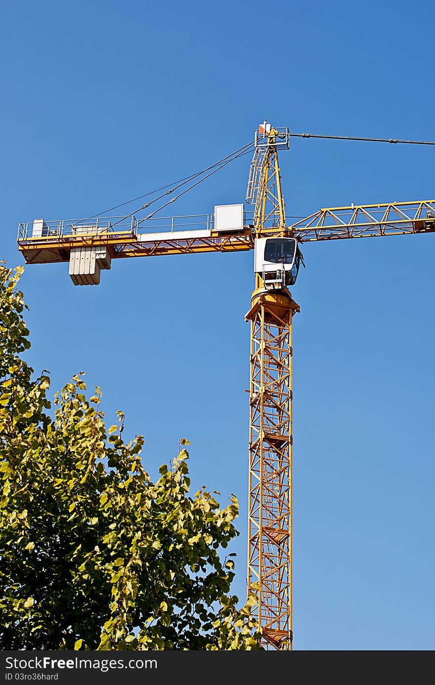 Yellow crane on blue sky background