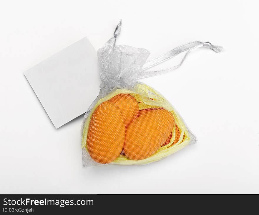 Dragee on a white background and a card for an inscription