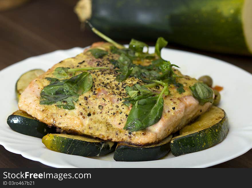 Tasty salmon filet on a white plate, with grilled vegetables. Tasty salmon filet on a white plate, with grilled vegetables