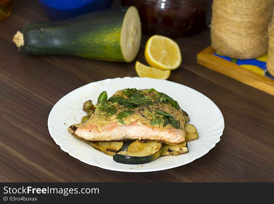 Tasty salmon filet on a white plate, with grilled vegetables. Tasty salmon filet on a white plate, with grilled vegetables