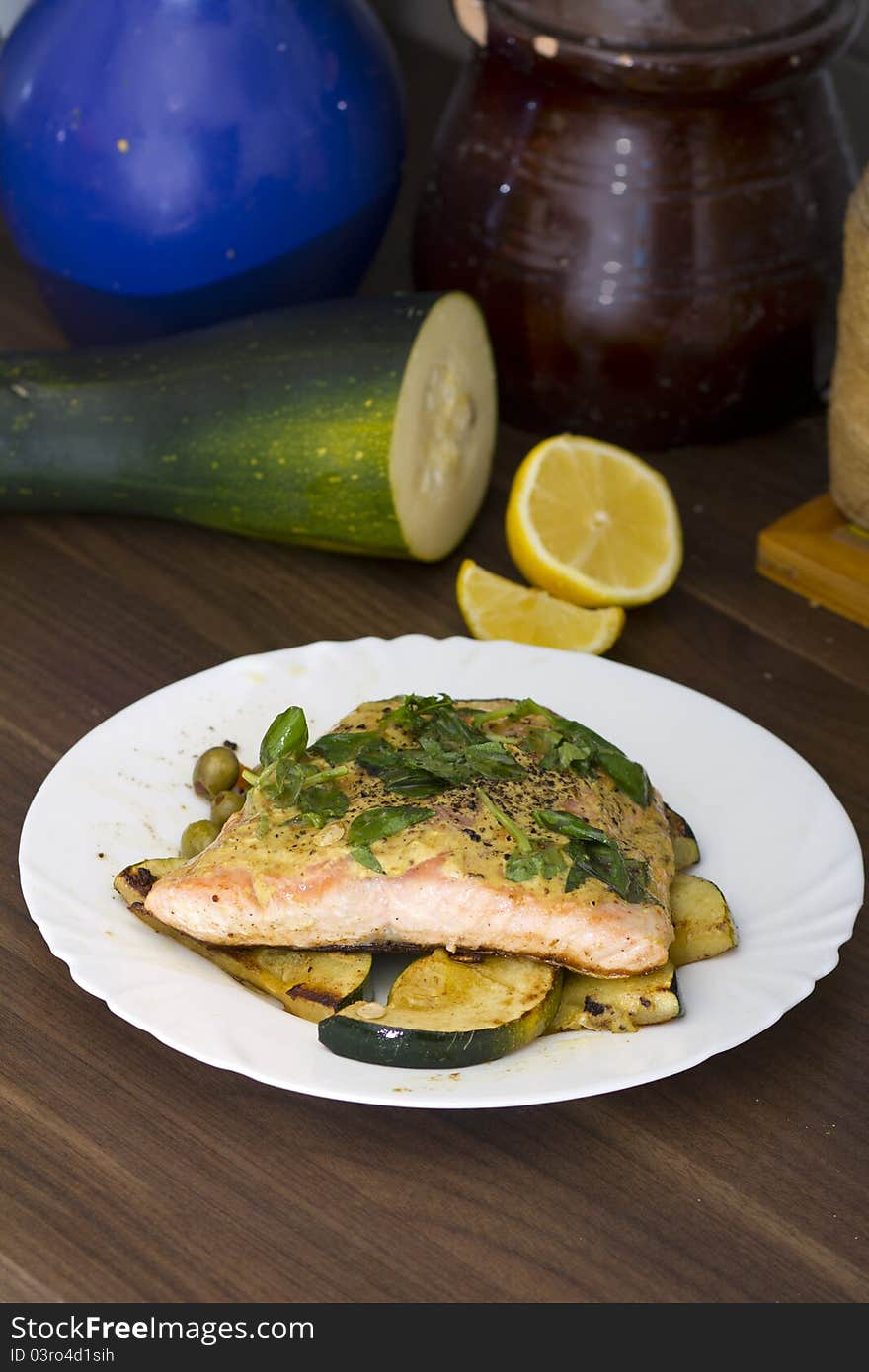 Tasty salmon filet on a white plate, with grilled vegetables. Tasty salmon filet on a white plate, with grilled vegetables