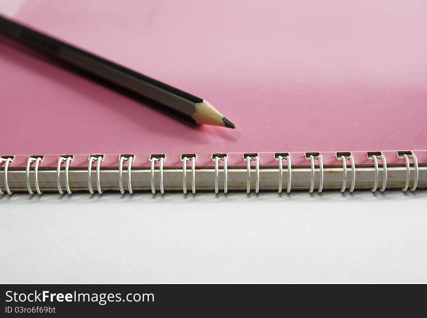 Notebook on the white with pencils. Notebook on the white with pencils.