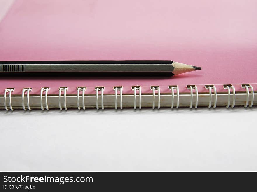 Notebook on the white with pencils. Notebook on the white with pencils.