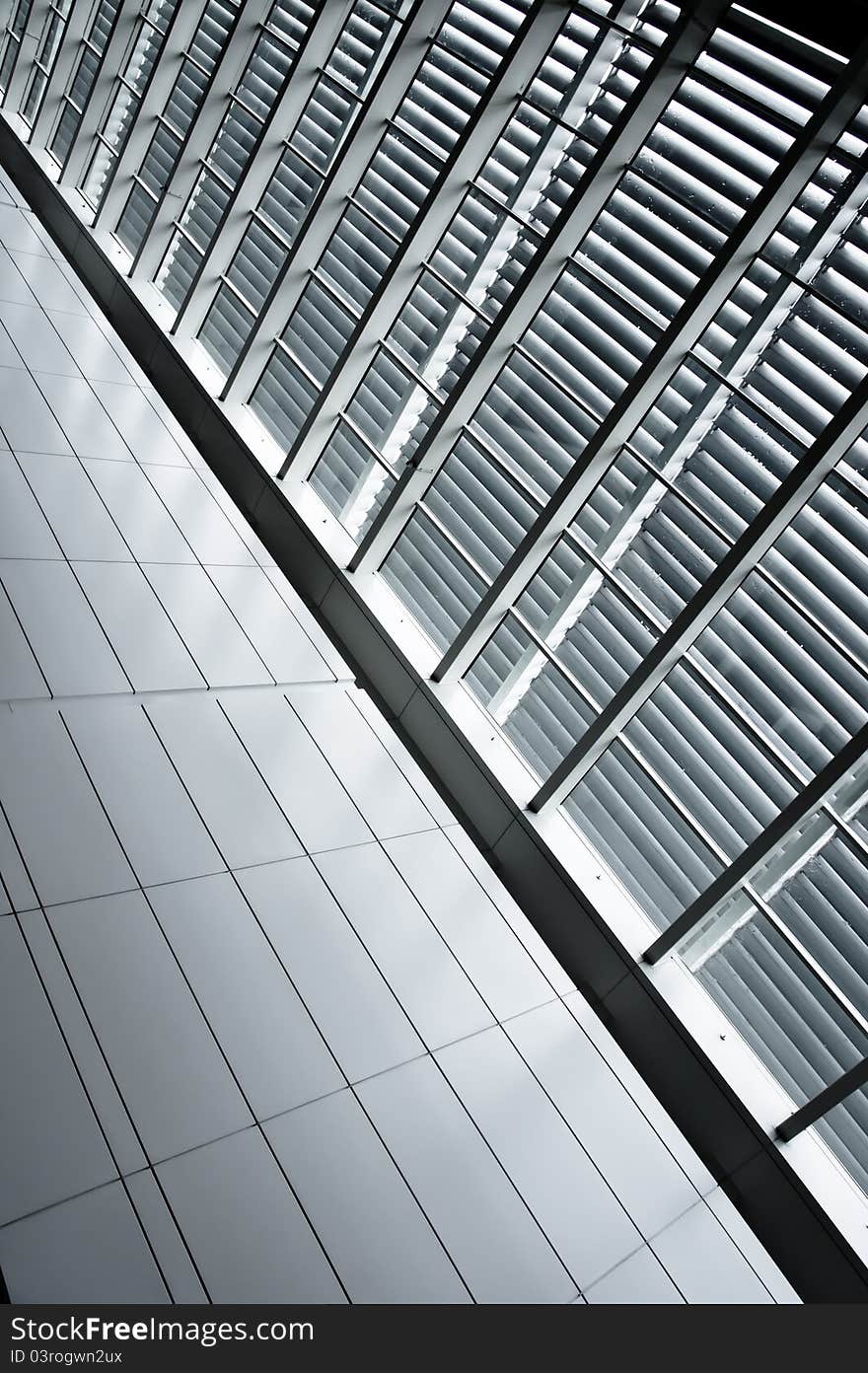 Contrast window panels with blinds beside tiled pathway