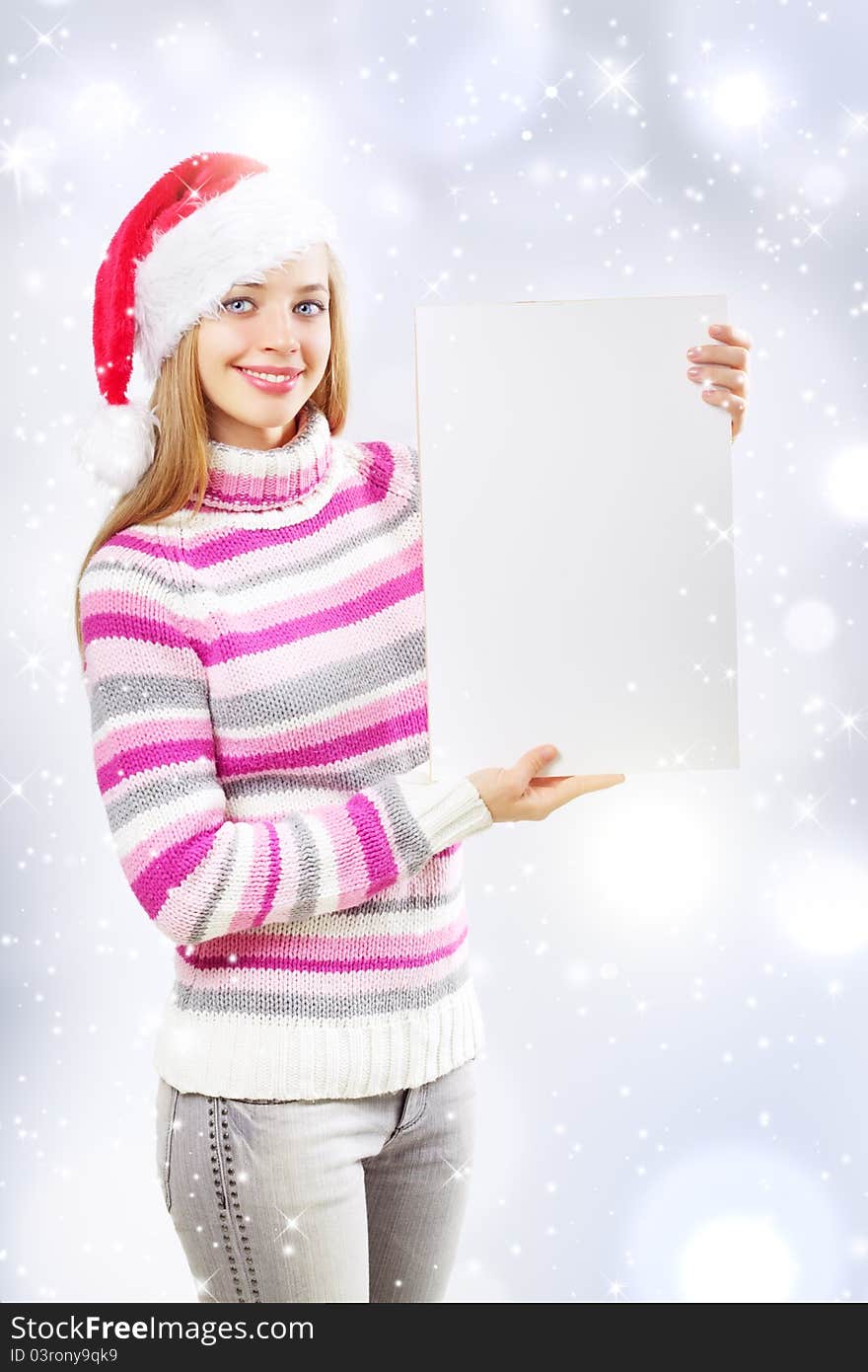 Santa girl holding blank sign on a light background