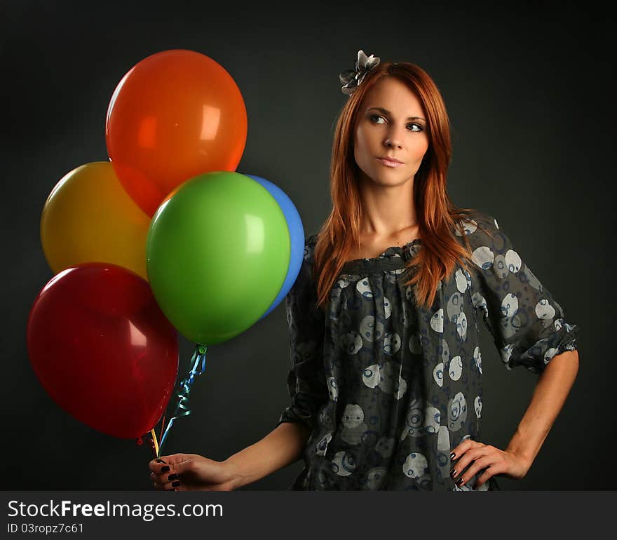 Woman with balloons on grey background