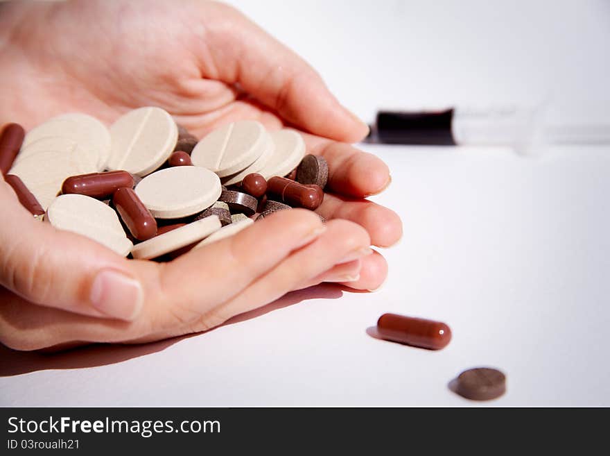 Image of drugs in female hands and syringe