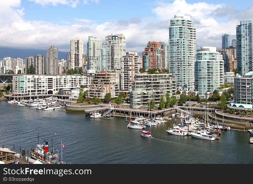 The Vancouver BC skyline from Granville bridge & Falls creek waterway and marinas. The Vancouver BC skyline from Granville bridge & Falls creek waterway and marinas.