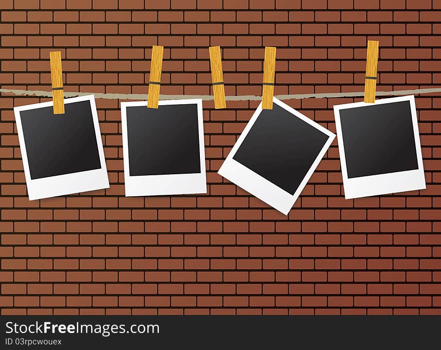 Group of instant photos hanging on a string on a brick wall. Group of instant photos hanging on a string on a brick wall