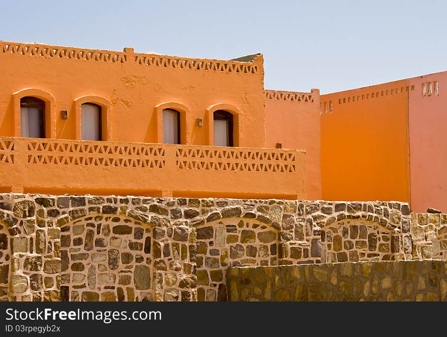 Nice orange hotel in Egypt with clear sky and wall