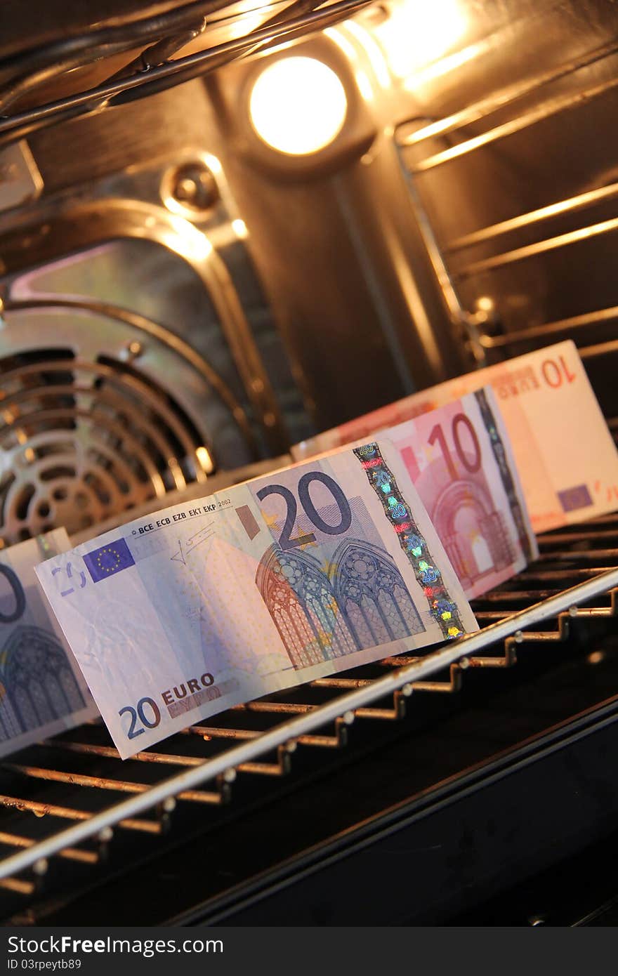 Many banknotes are baking in the stove. Many banknotes are baking in the stove