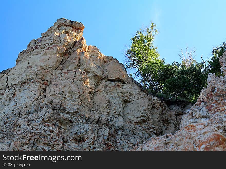 Reddish crumbling rock on the bank of the Volga River. Reddish crumbling rock on the bank of the Volga River.