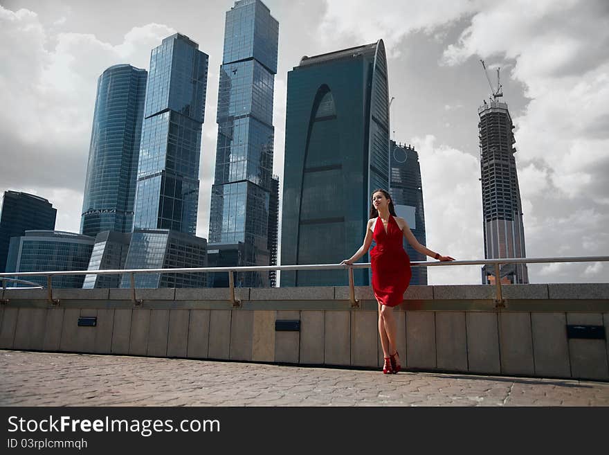 Beautiful girl in the background of glass buildings. Beautiful girl in the background of glass buildings