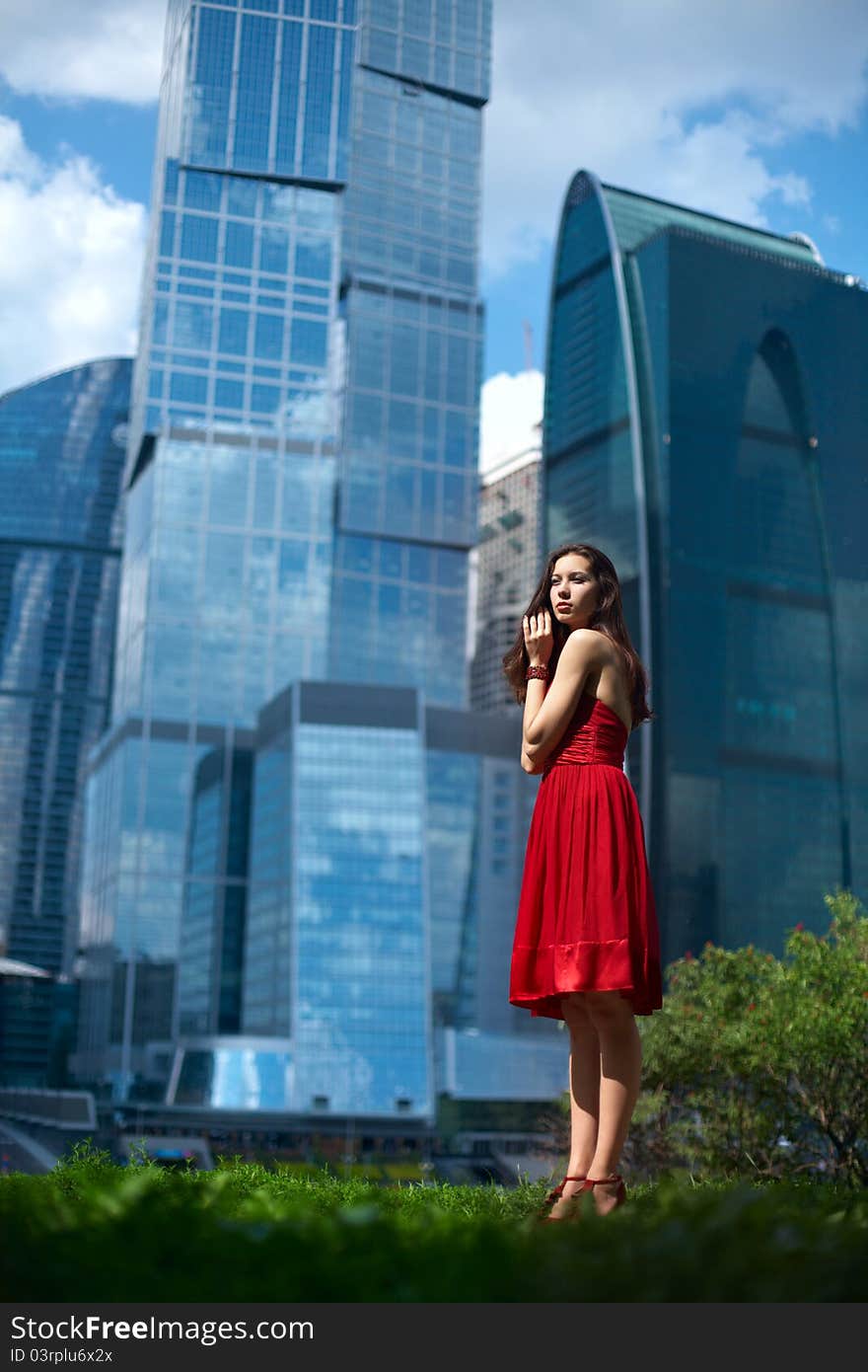 Beautiful girl in the background of glass buildings. Beautiful girl in the background of glass buildings