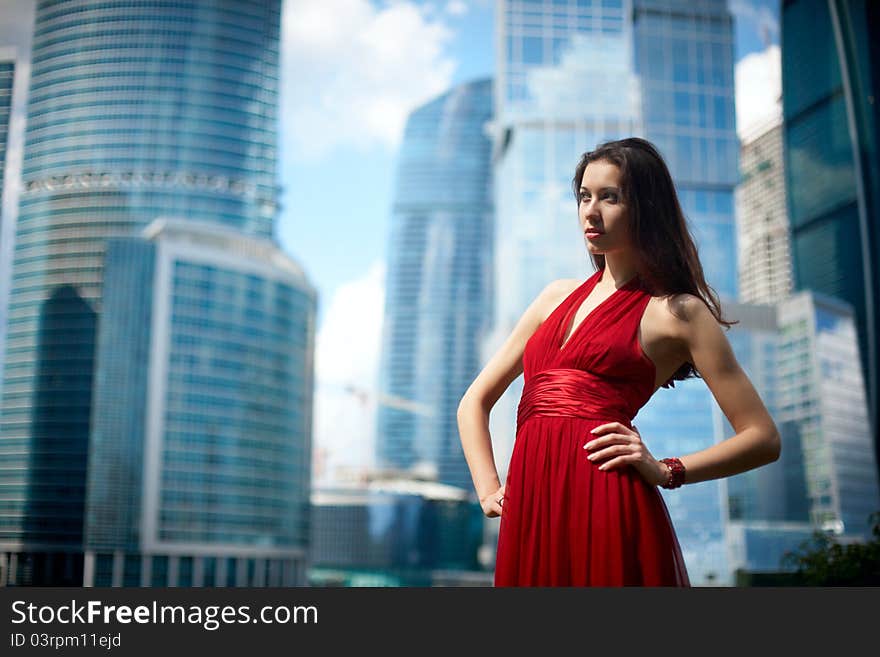 Beautiful girl in the background of glass buildings. Beautiful girl in the background of glass buildings