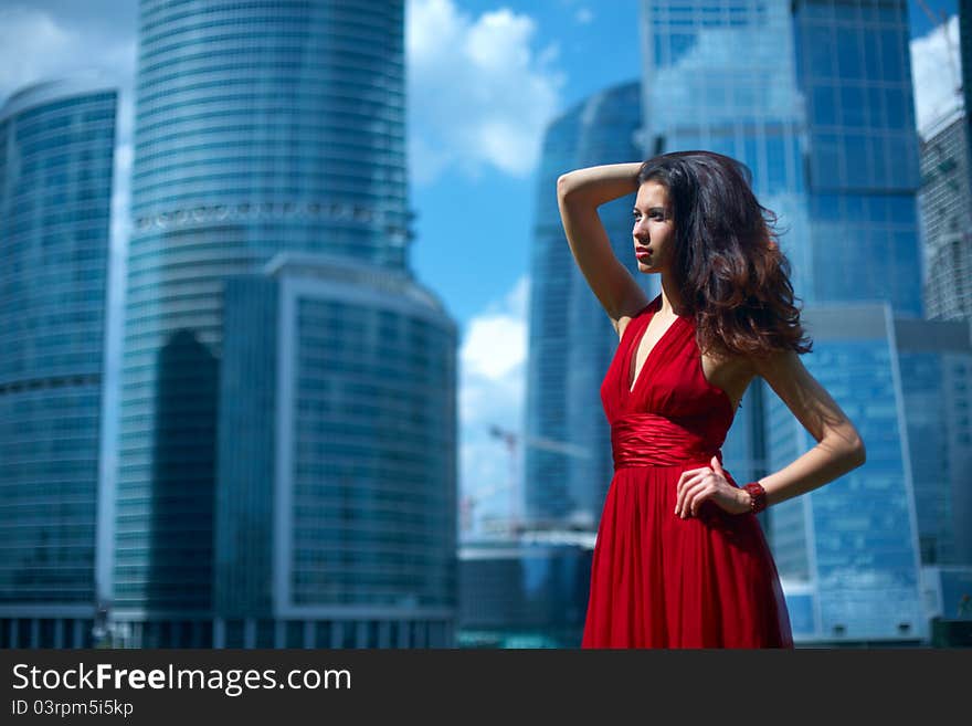 Beautiful girl in the background of glass buildings. Beautiful girl in the background of glass buildings