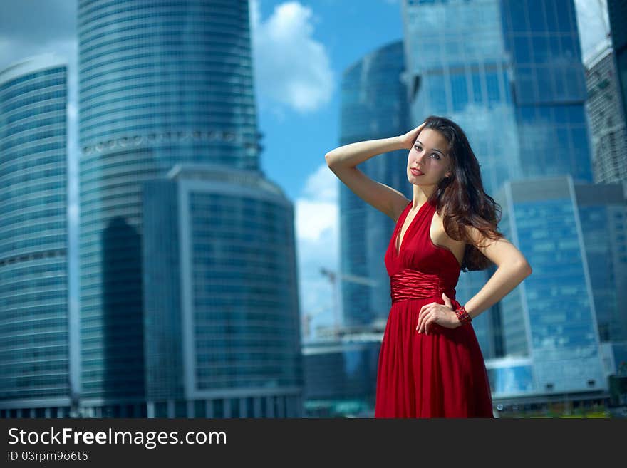 Beautiful girl in the background of glass buildings. Beautiful girl in the background of glass buildings