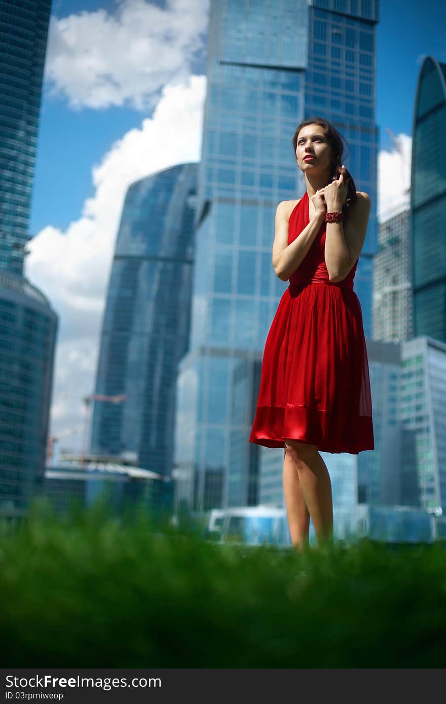 Beautiful girl in the background of glass buildings. Beautiful girl in the background of glass buildings