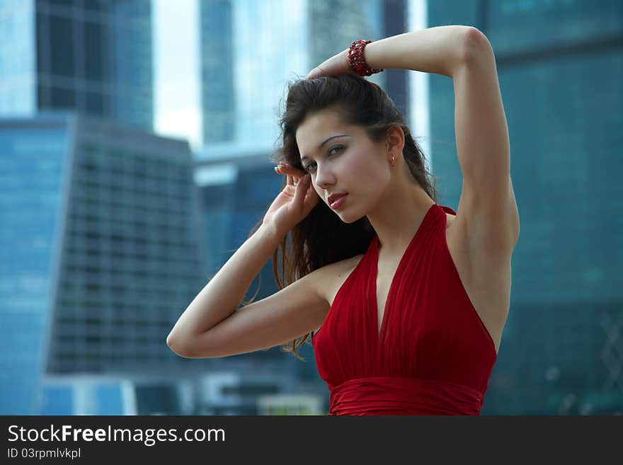 Beautiful girl in the background of glass buildings. Beautiful girl in the background of glass buildings