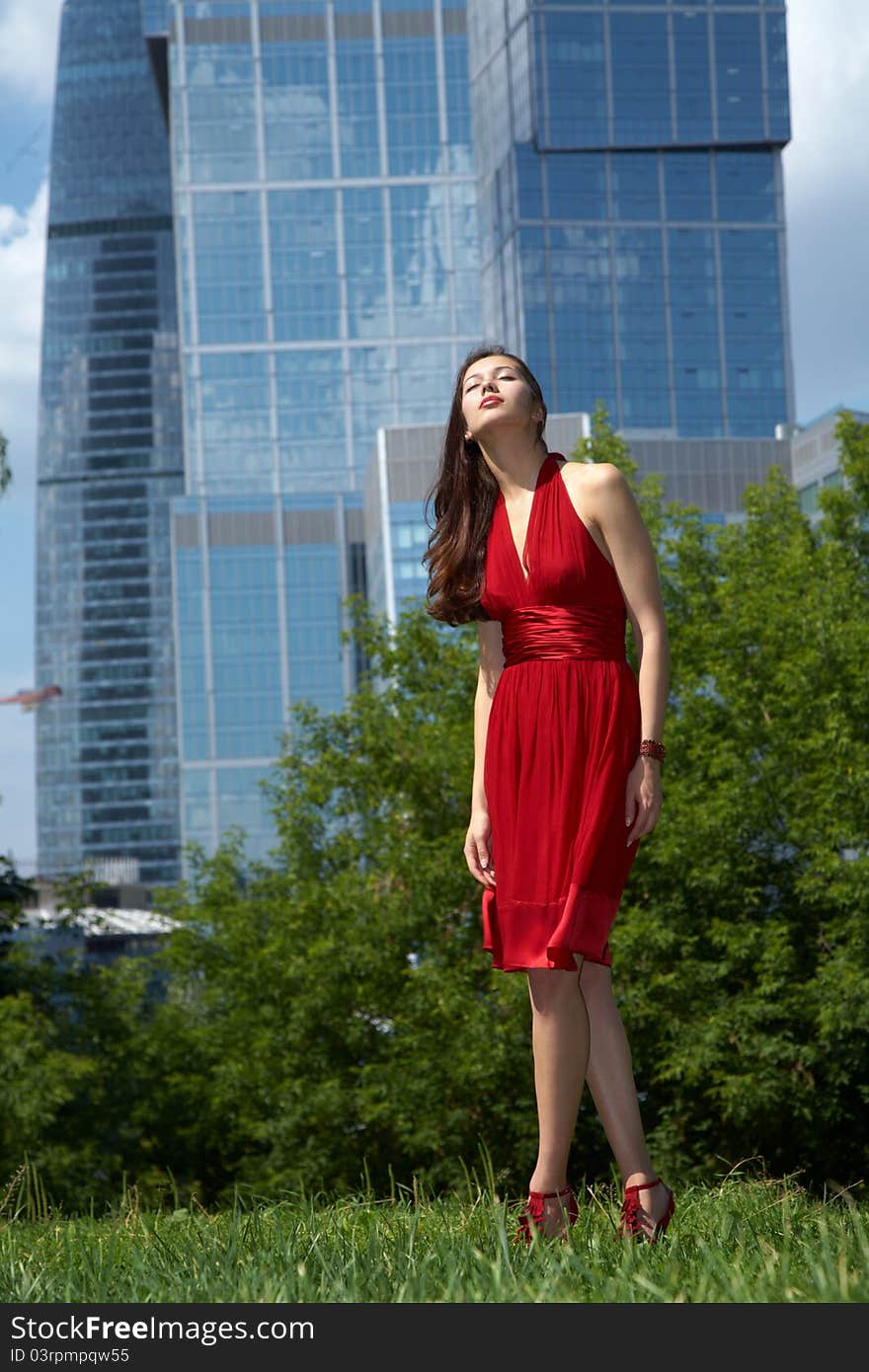 Beautiful girl in the background of glass buildings