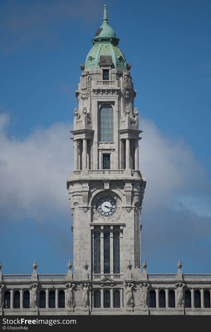 A majestic clock tower in the central square of Porto, Portugal.