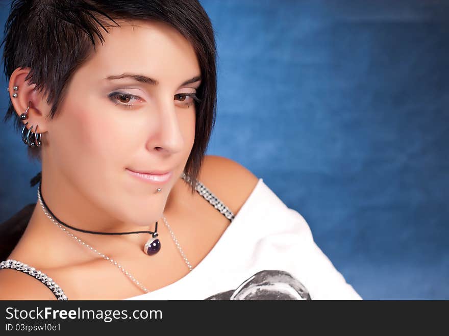 Brunette teenager girl with rock attitude on blue background