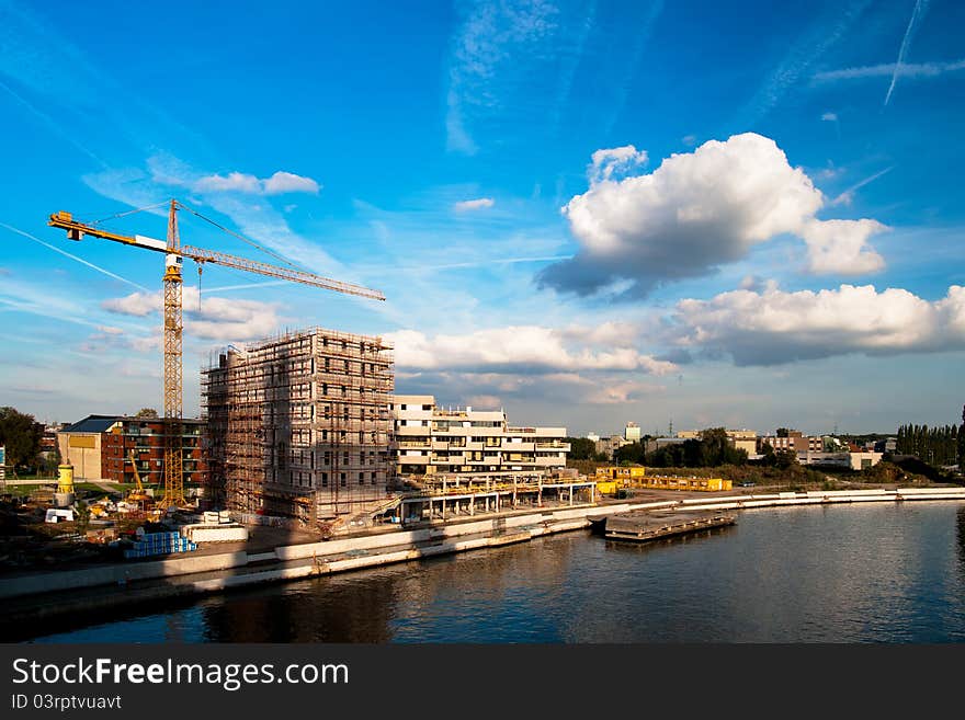 Crane and a building structure on the embankment of the river. Crane and a building structure on the embankment of the river