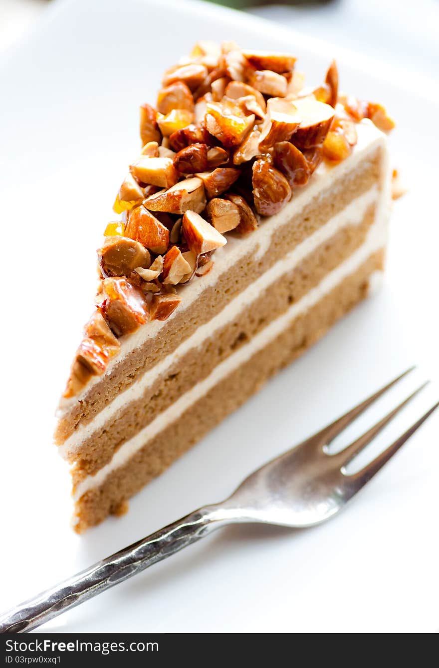 A delicious coffee almond cake on white dish