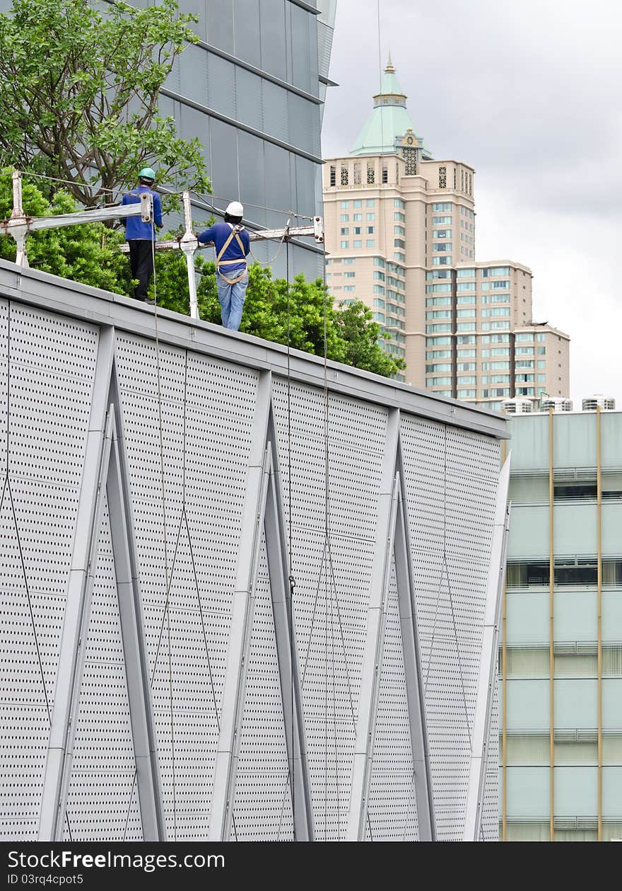 High worker on roof of building