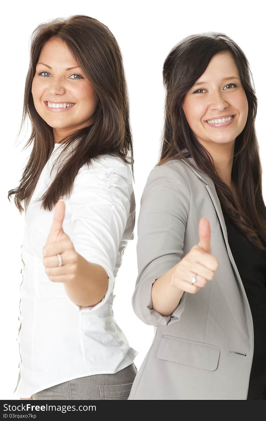 Portrait of two businesswomen showing thumbs up