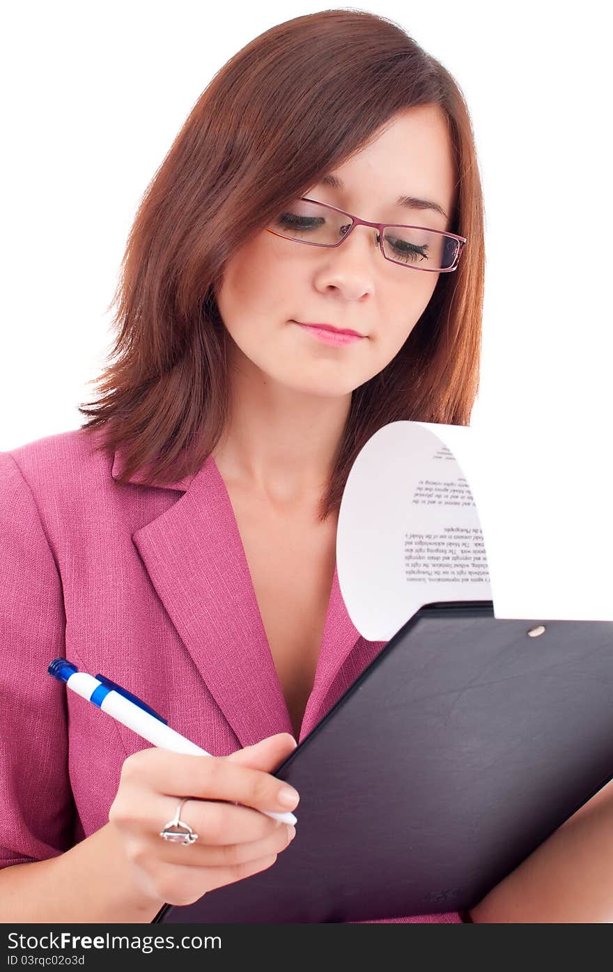 Portrait of a young businesswoman writing on a notebook