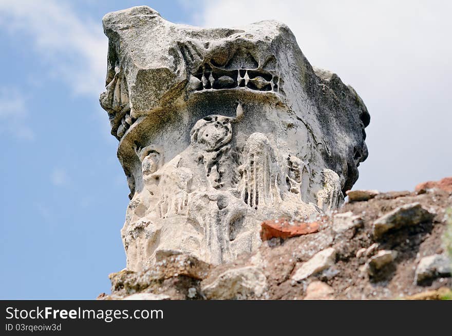 Ancient marble capitel against a blue sky. Rome, Italy. Ancient marble capitel against a blue sky. Rome, Italy