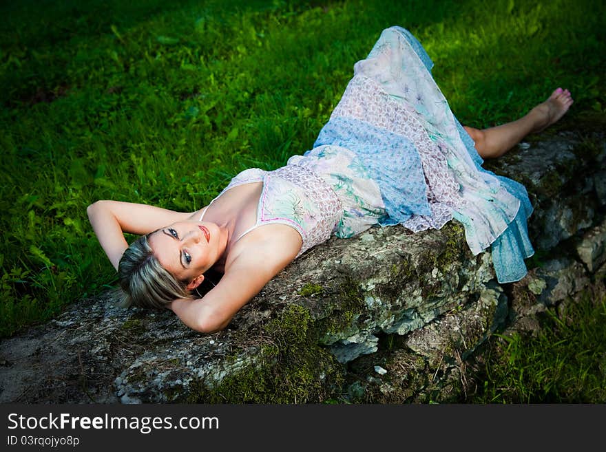 Attractive Woman Lying On Stones