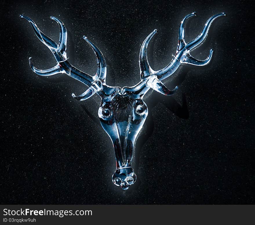 Glass head deer on dark background. Glass head deer on dark background.