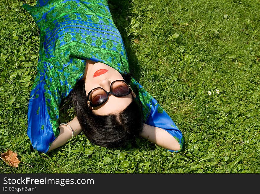 Girl resting on grass in park