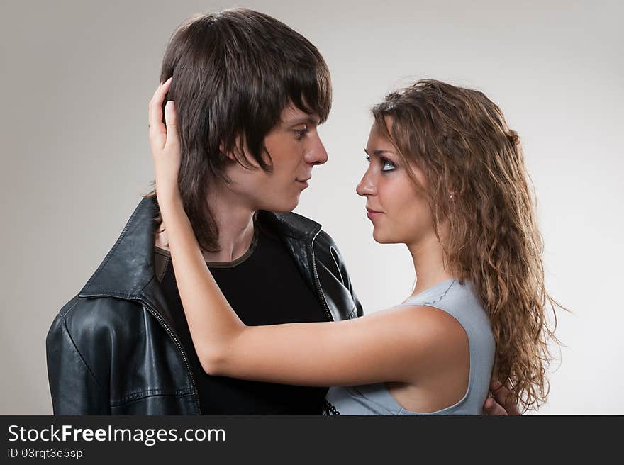 Picture of a tender young couple, men and women posing in studio. Picture of a tender young couple, men and women posing in studio