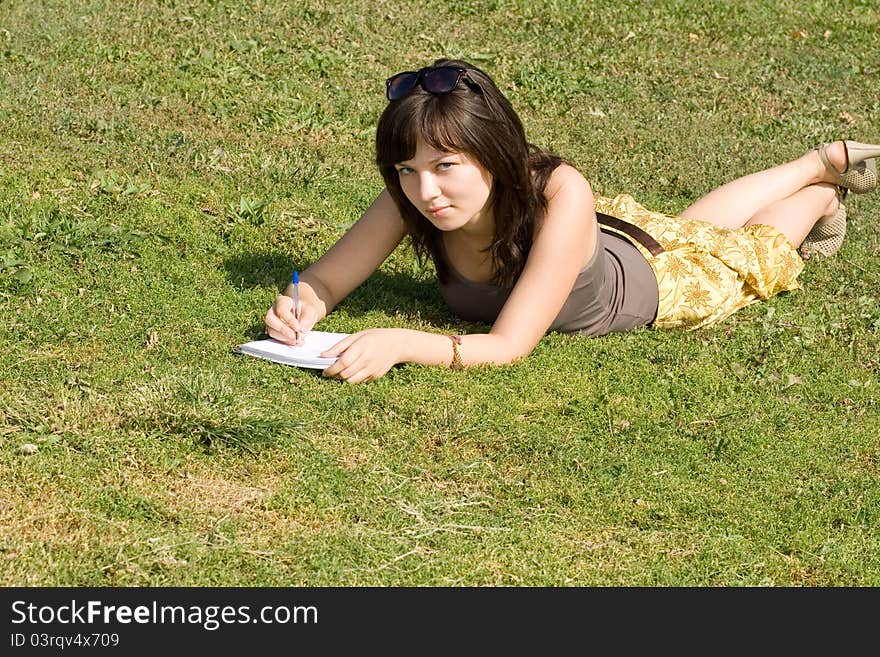 Girl lying on grass in park