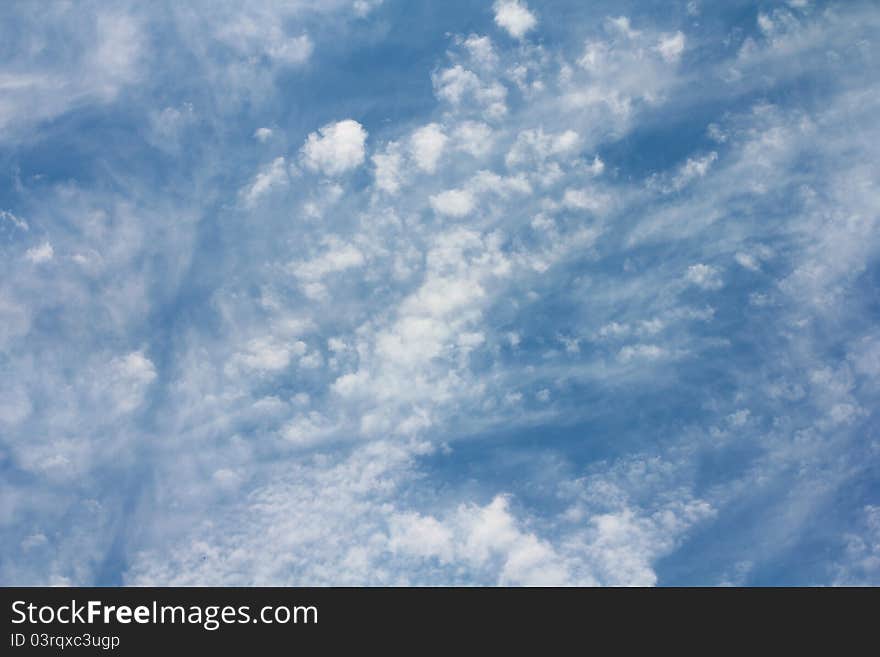 White fluffy clouds on the background of blue sky