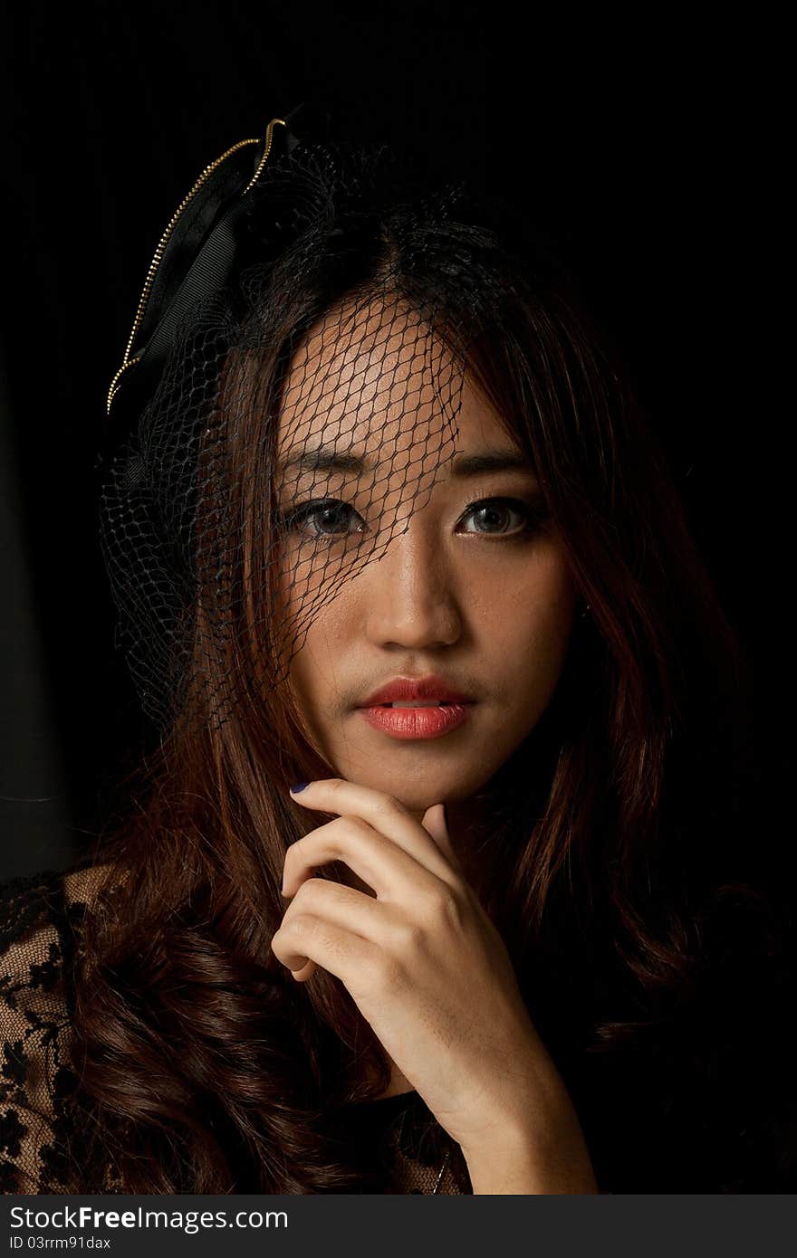 Beautiful young Asian female low key in black dress. Beautiful young Asian female low key in black dress