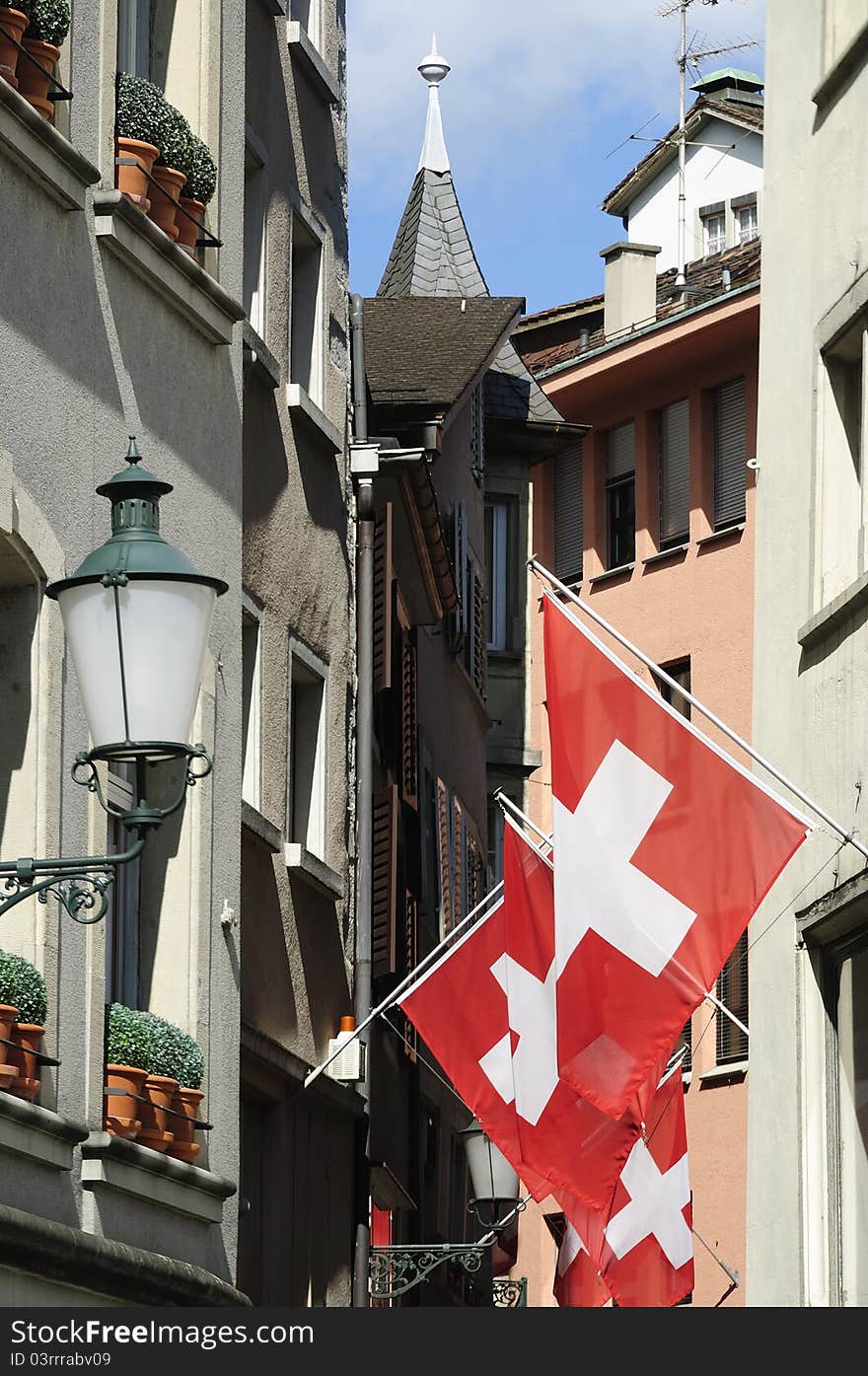 Zurich Switzerland alley in summer with Swiss flag.