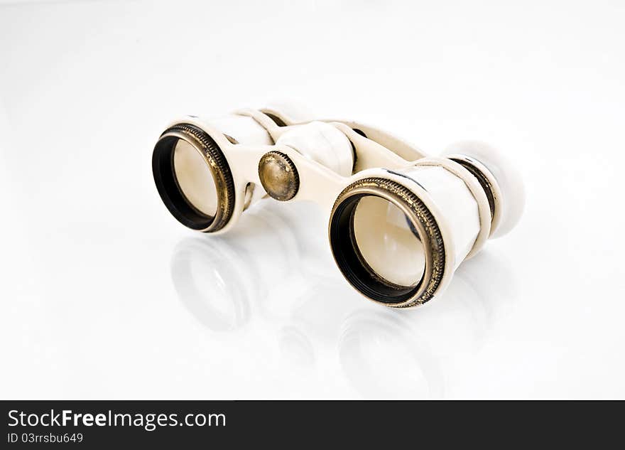 Old white opera binoculars on a white background. Old white opera binoculars on a white background