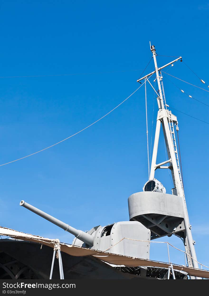 Gray metal canon on battleship deck and mast. Gray metal canon on battleship deck and mast