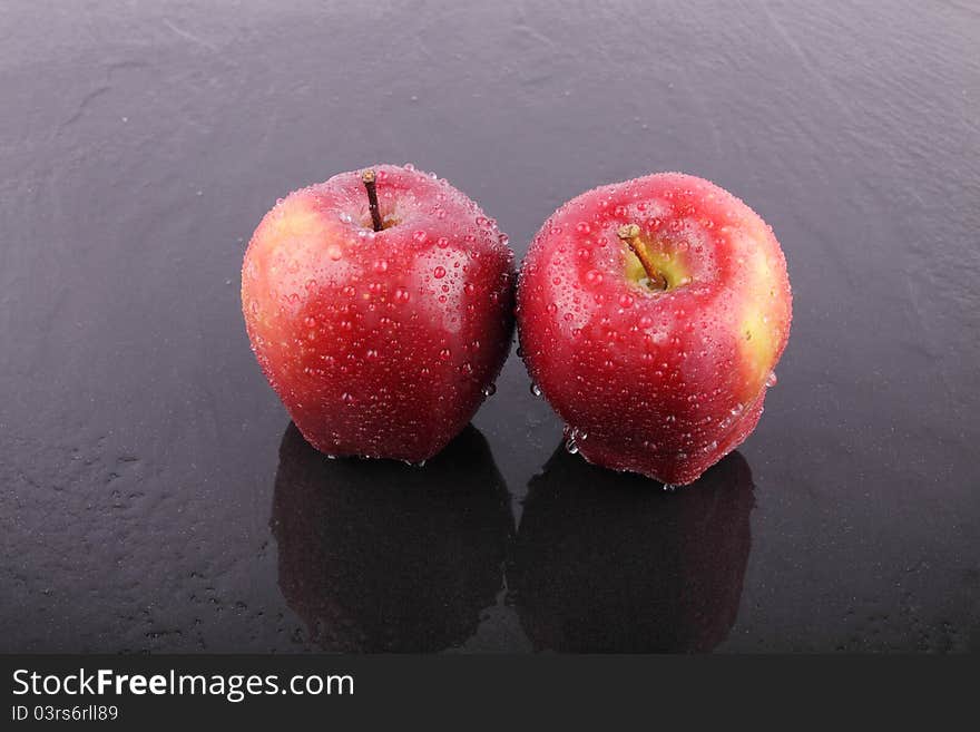 Two red apple on wet floor. Two red apple on wet floor