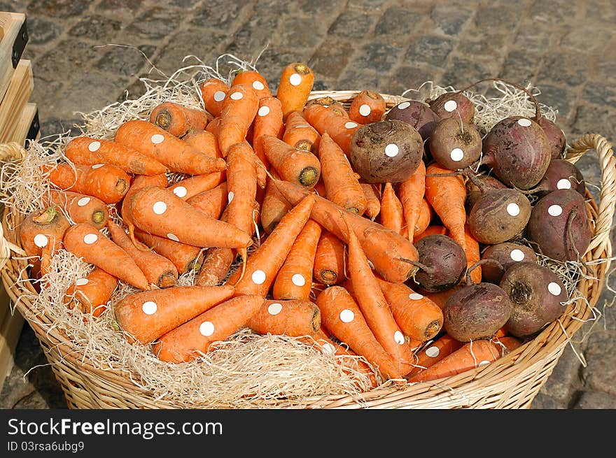 Large basket of carrots and beets in the market. Large basket of carrots and beets in the market