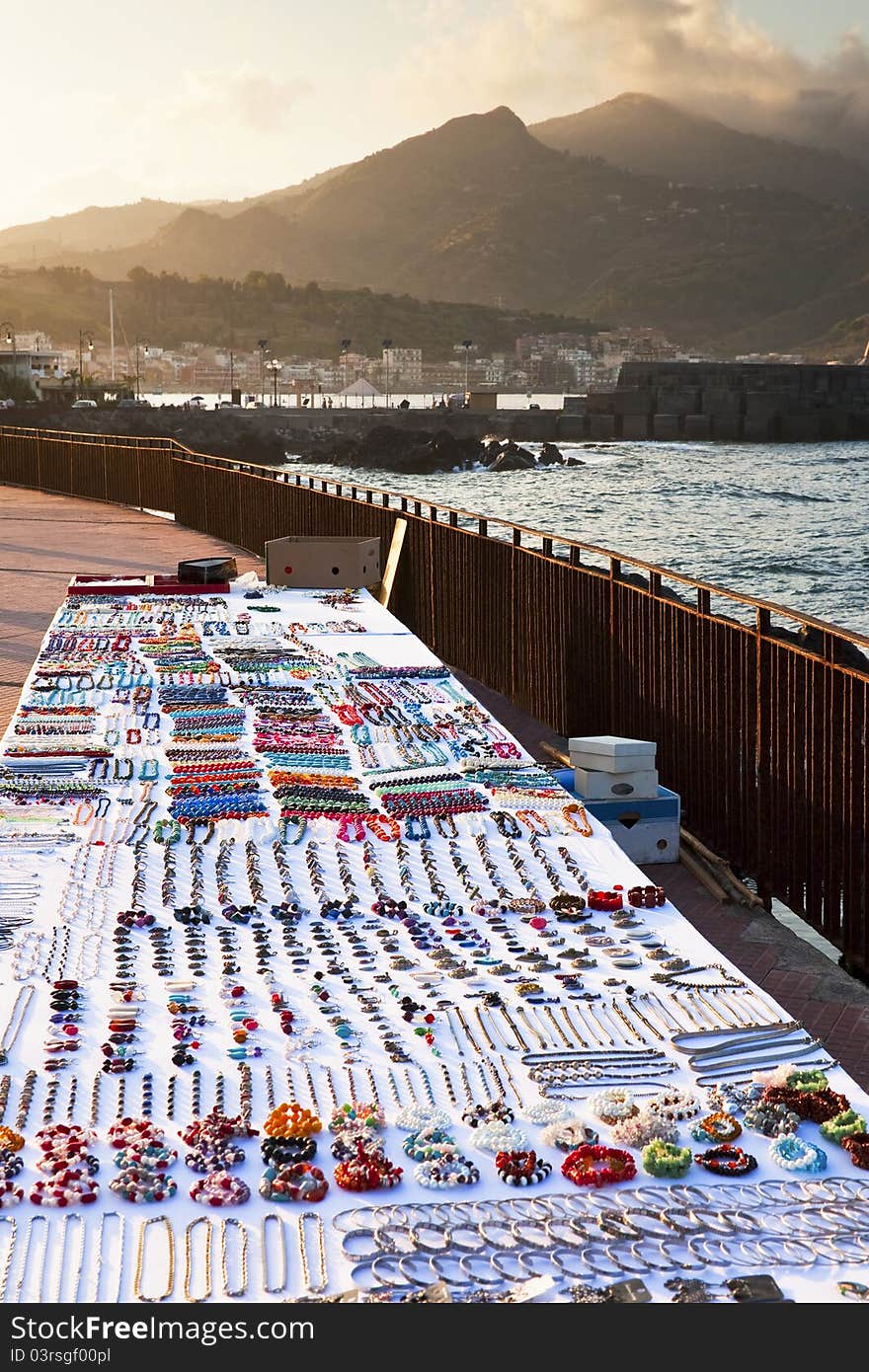 Table with bijouterie on seafront at sunset, Sicily. Table with bijouterie on seafront at sunset, Sicily