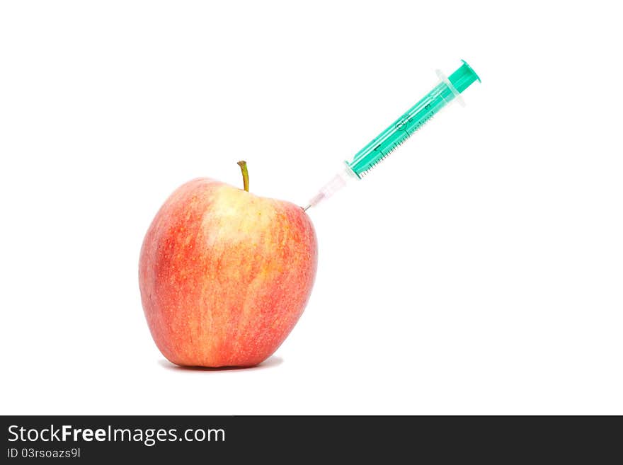 Red apple with a syringe on white background. Red apple with a syringe on white background