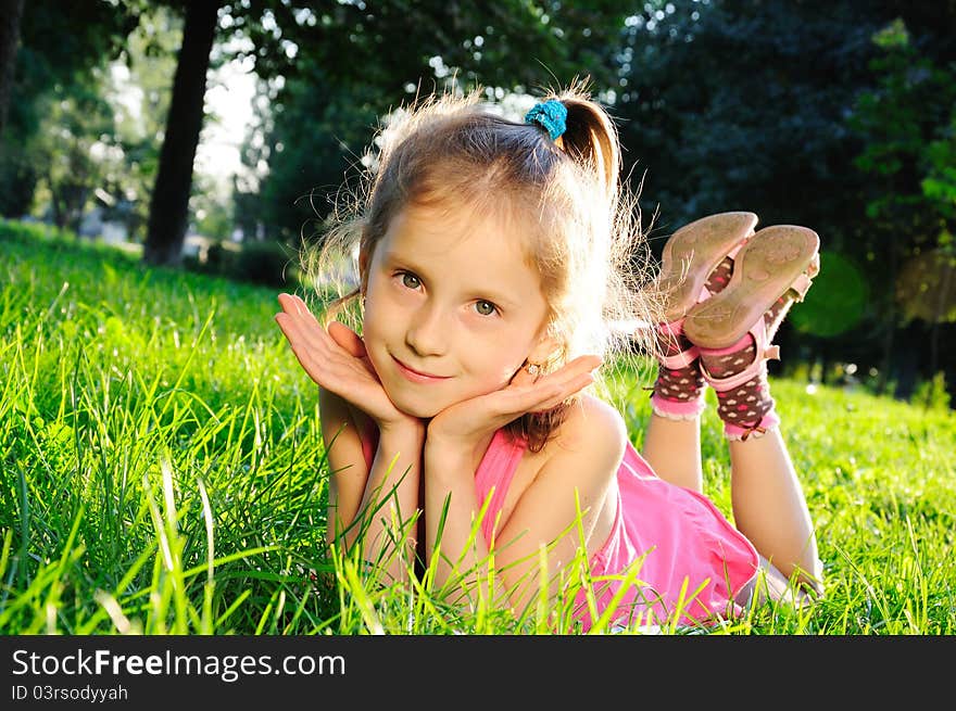 Portrait of little girl on grass